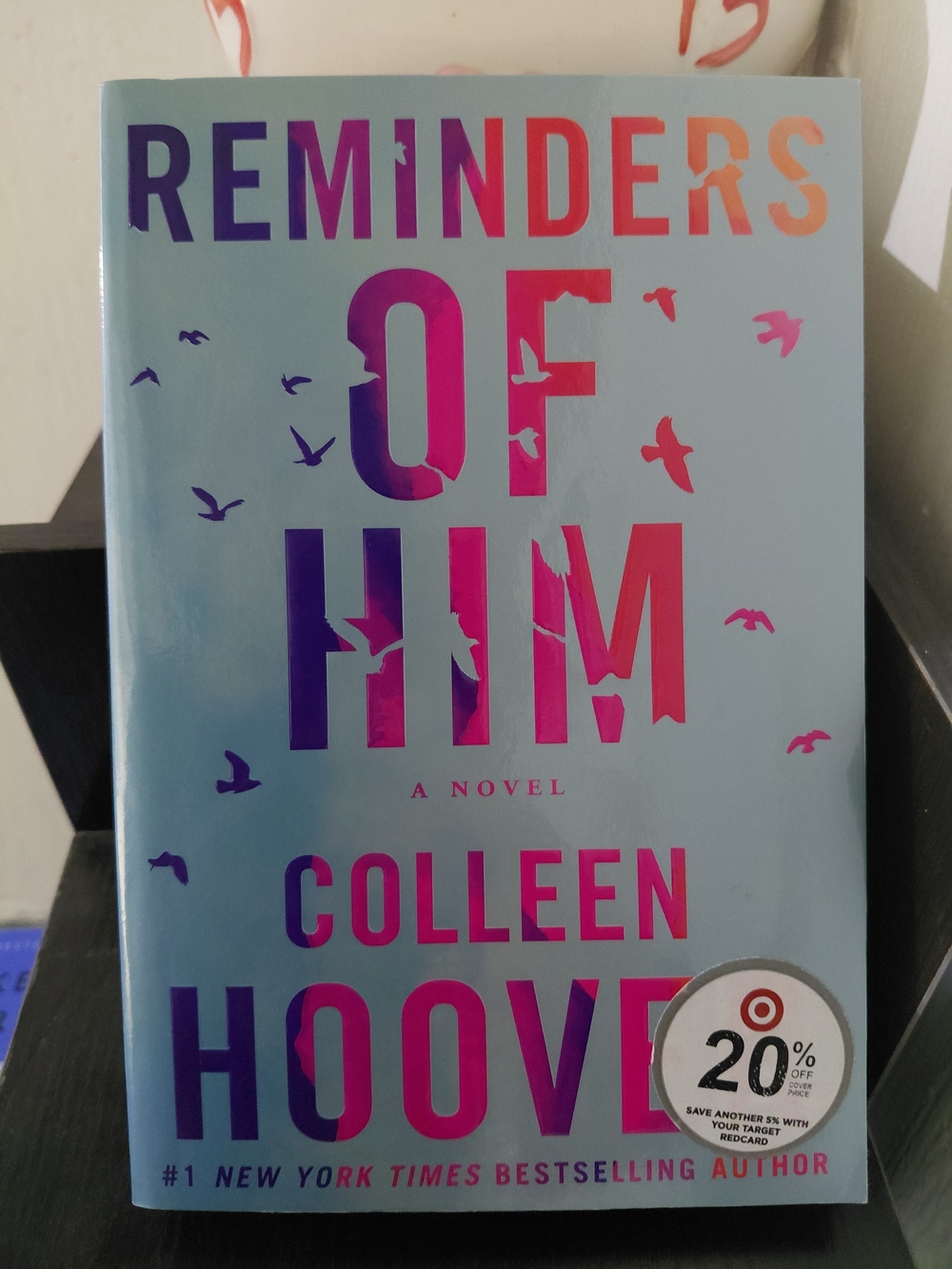 Reminders of Him by Colleen Hoover - Blue Cover with Pink/Purple Ombre Text
